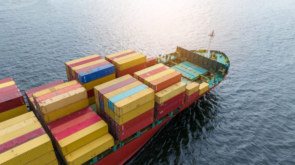 cargo maritime ship with contrail in the ocean ship carrying container and running for export