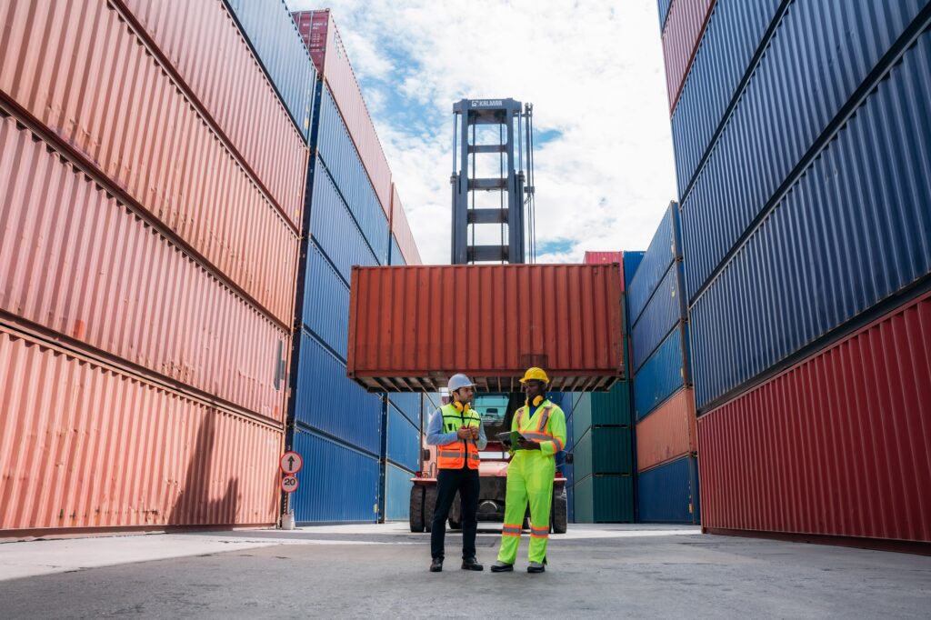 Industrial Engineer checking inventory or task details at Container cargo harbor. Logistics Expert O
