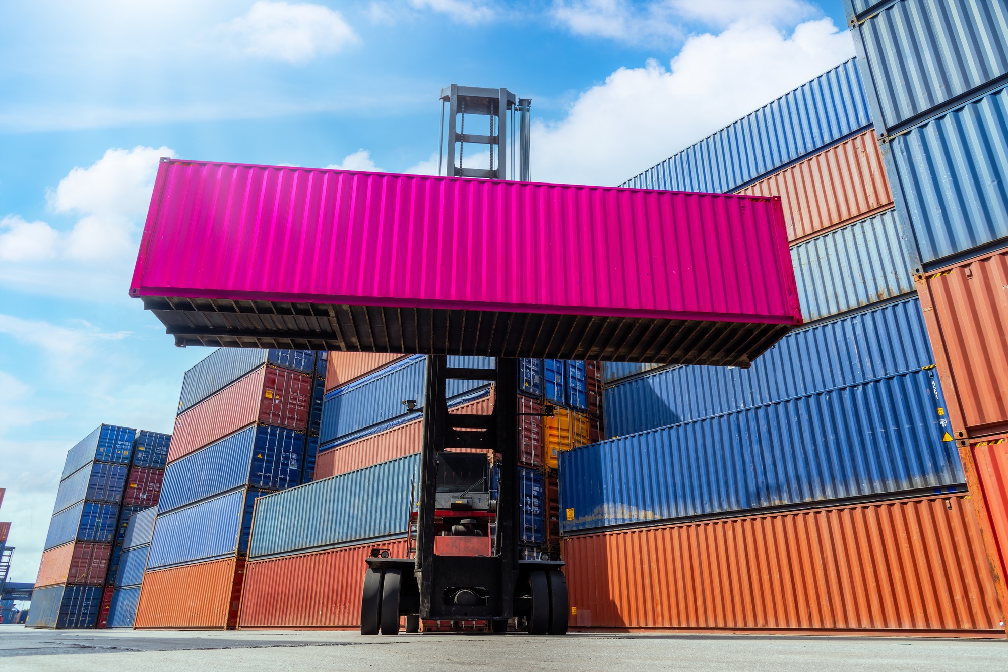 Transportation logistics and container dock cargo yard forklift truck working crane bridge in shipya
