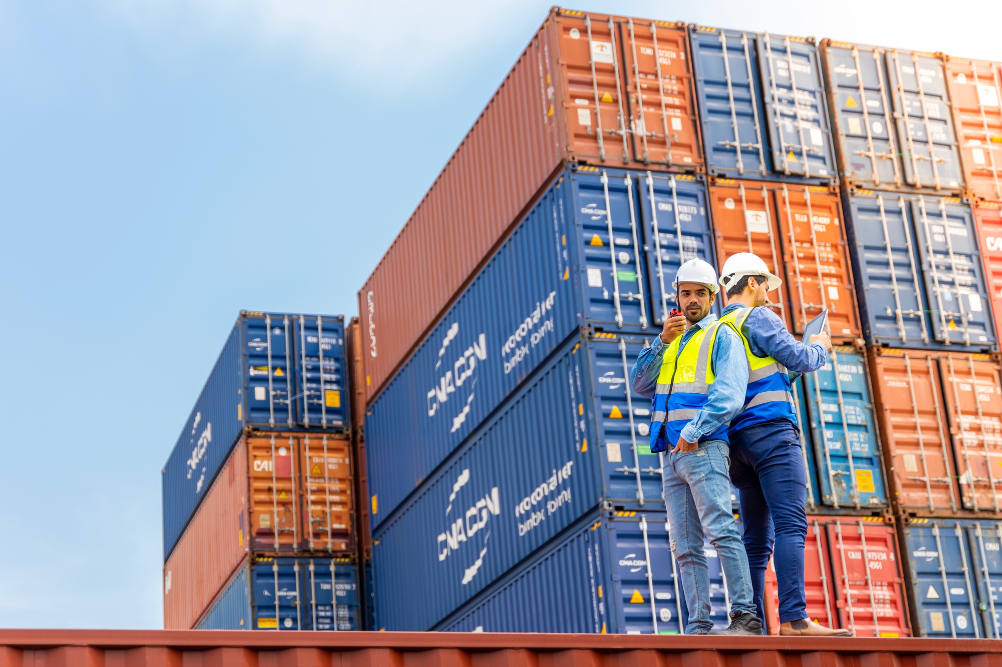 Two male engineers in a container shipping company Consulting