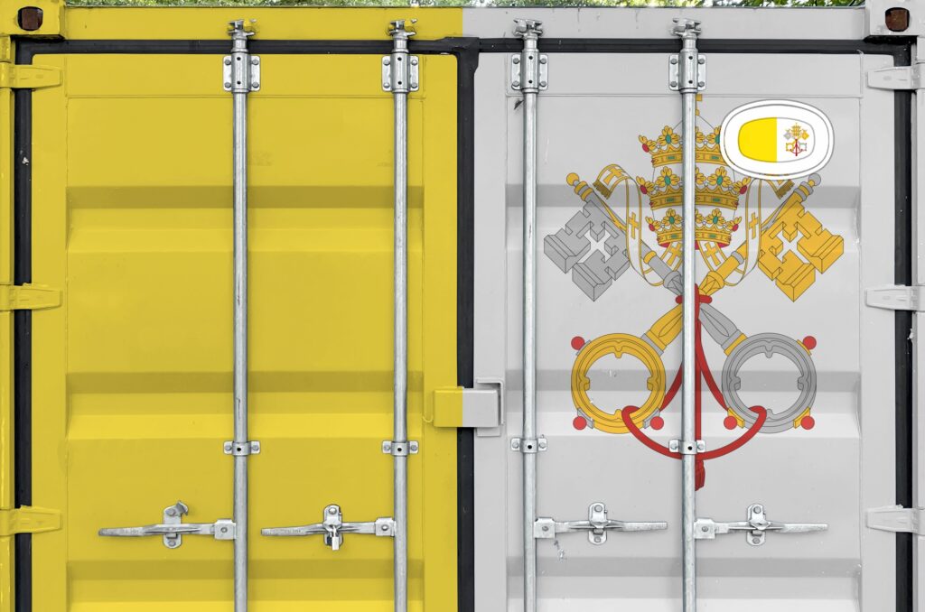 Vatican City State flag depicted on metal doors of shipping cargo container outdoors in docks area